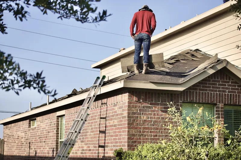 Professional roofer working on a residential roof in White Oaks
